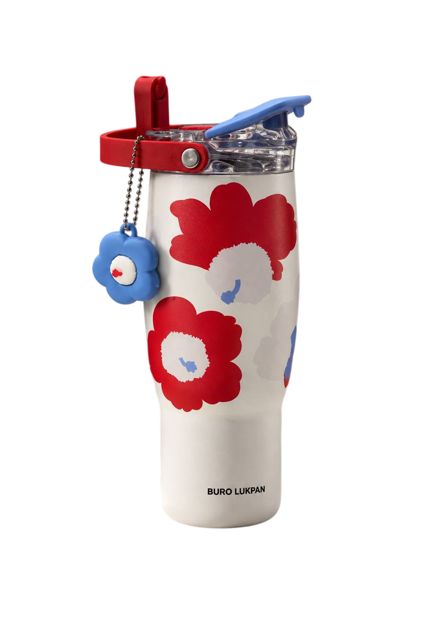 White travel cup with red flowers and a blue lid